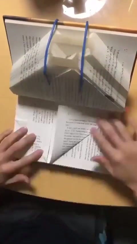 Folding book pages to spell "inspire"