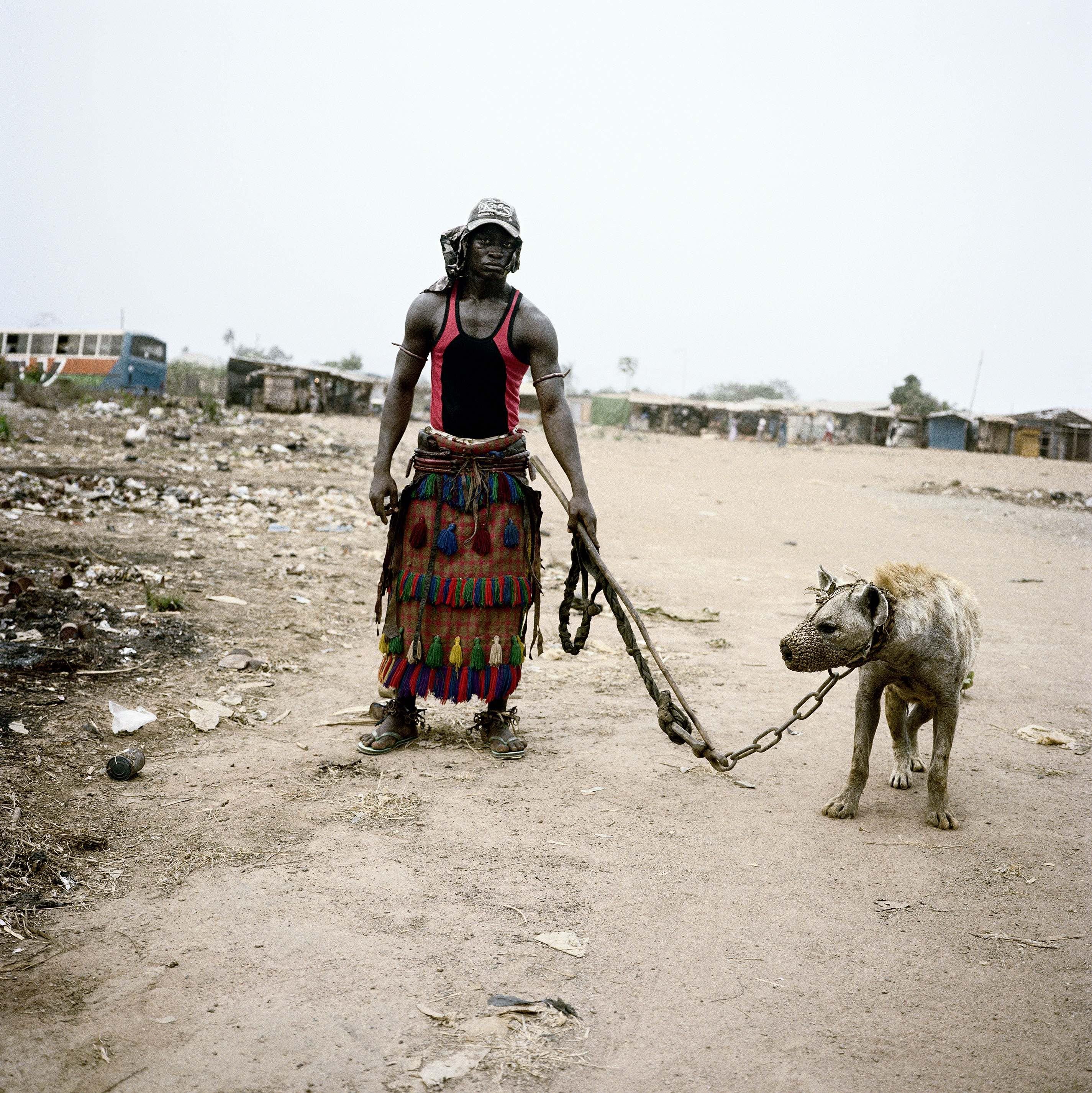 PsBattle: an african man leading a hyena