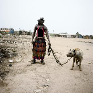 PsBattle: an african man leading a hyena